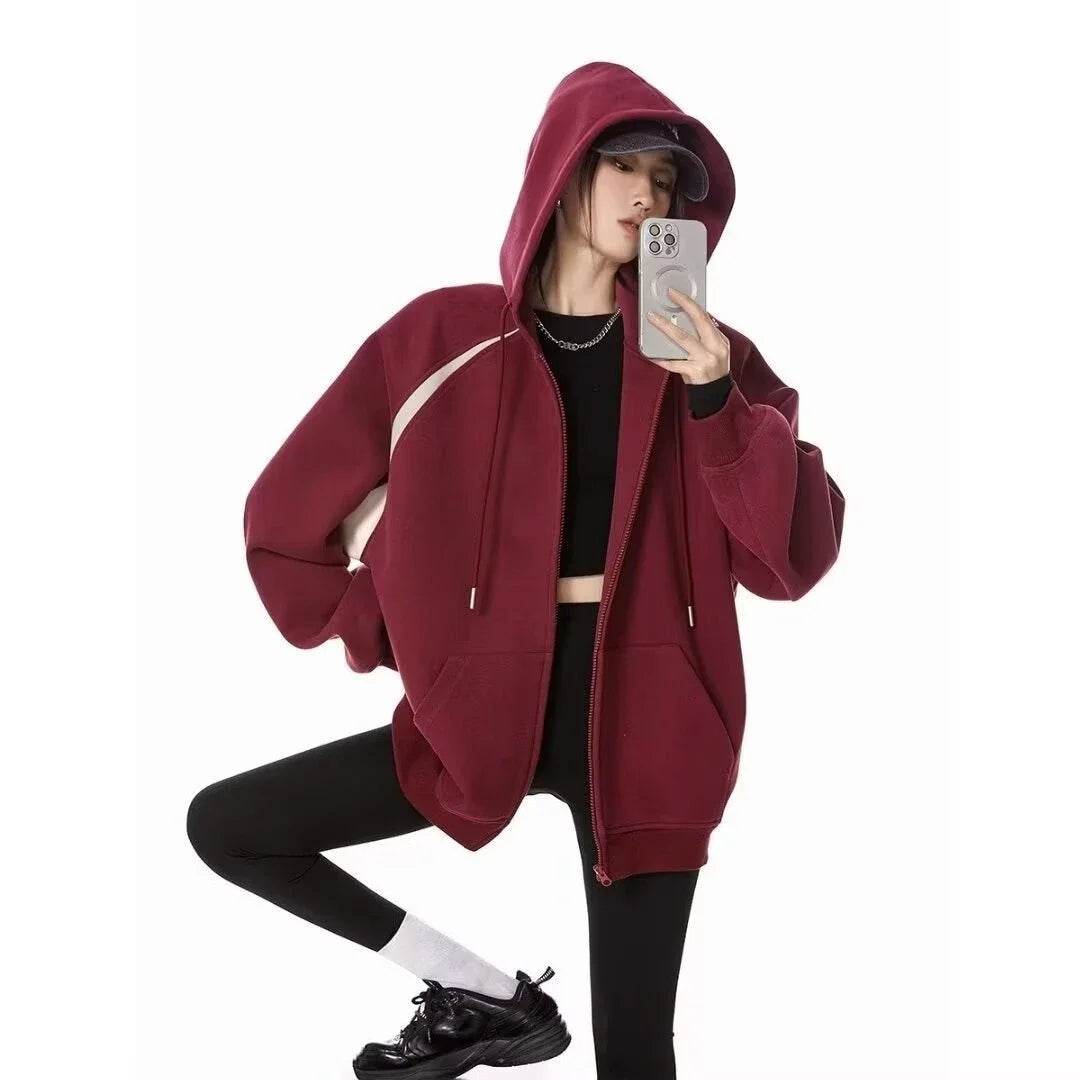 Women wearing a stylish burgundy women's autumn winter hoodie 2025 with a zipper, perfect for casual outings.