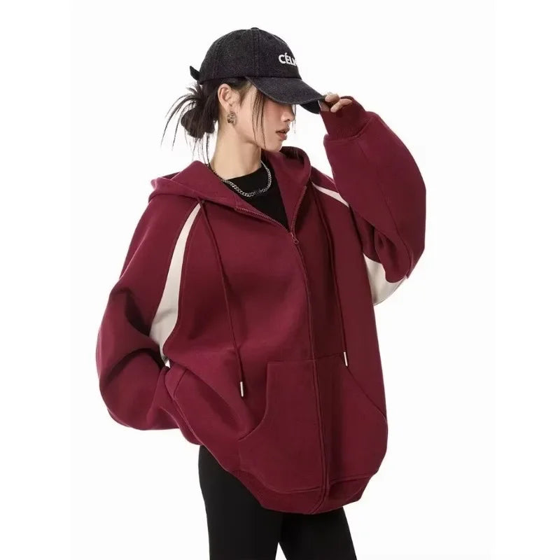 Women wearing a stylish burgundy women's autumn winter hoodie 2025 with a zipper, perfect for casual outings.