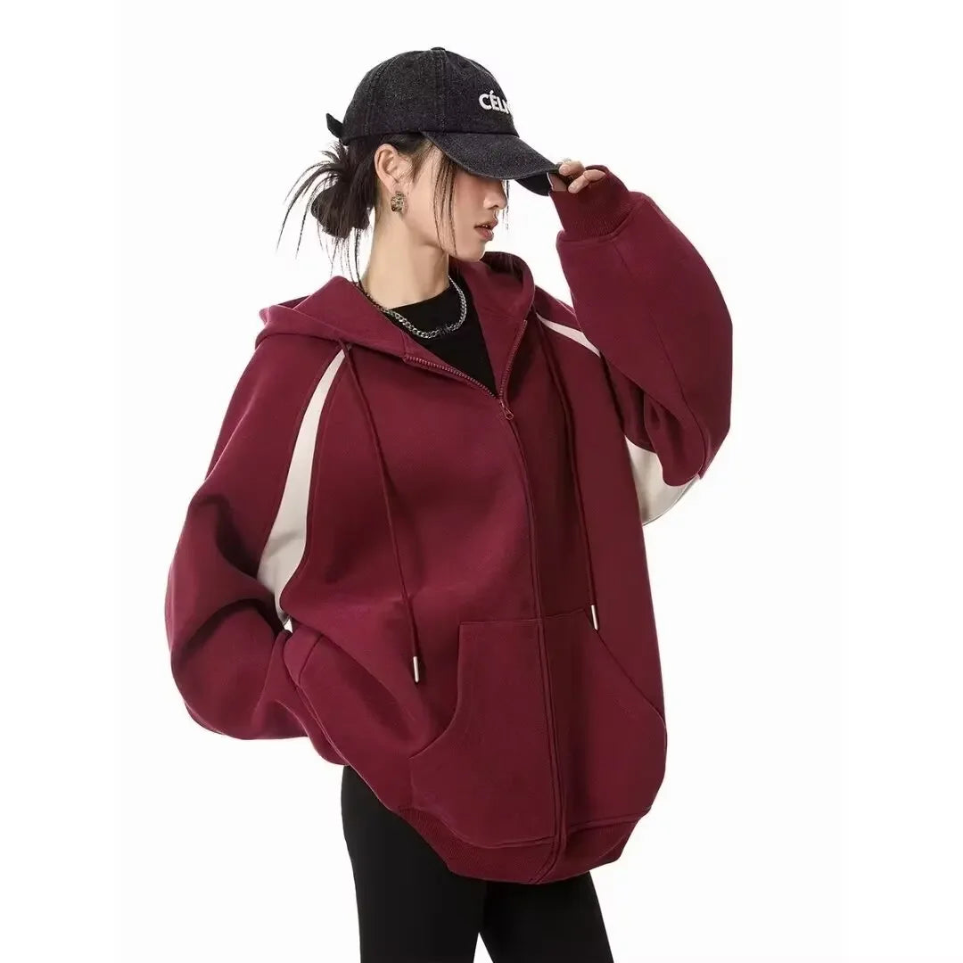 Women wearing a stylish burgundy women's autumn winter hoodie 2025 with a zipper, perfect for casual outings.