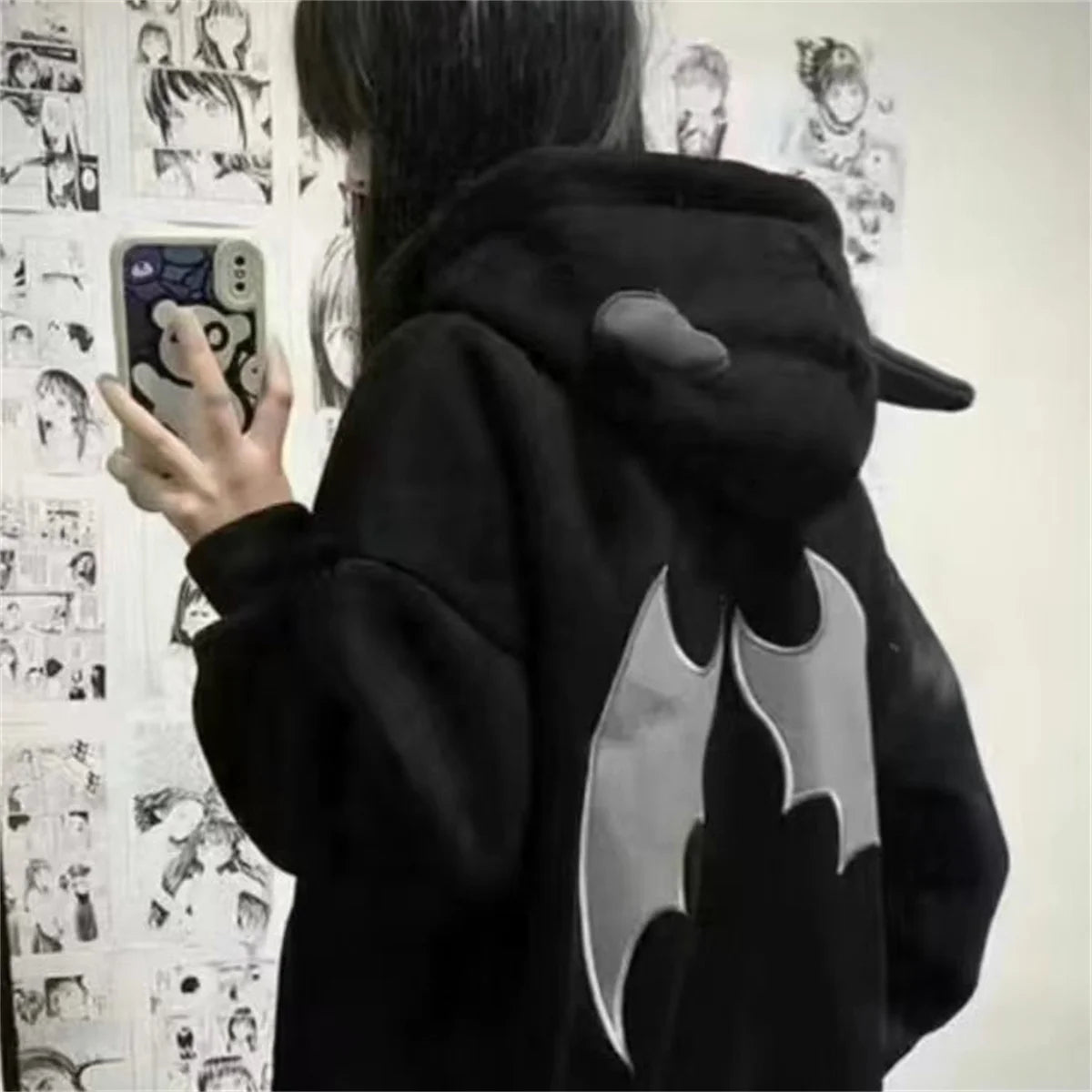 Evil Horns Hoodies Women featuring bat wing design on the back in a casual setting